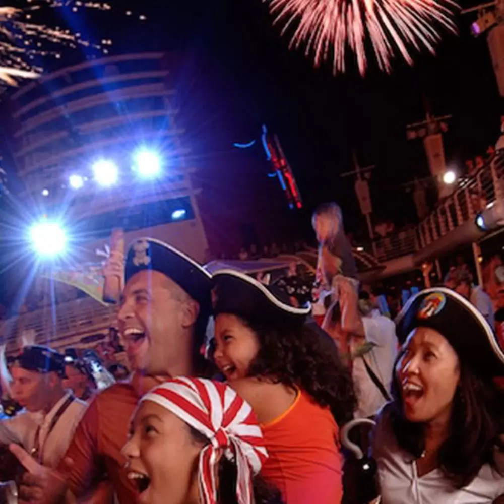 DisneyCruiseLine- family in pirate costumes fireworks